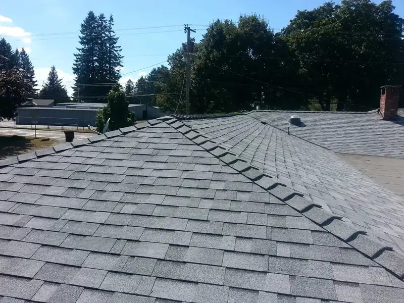 Grey laminated shingle ridge cap detail